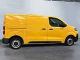 the yellow van is parked in a large room with a gray floor