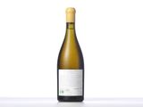 a bottle of white wine sitting on top of a table
