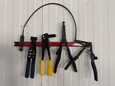 many tools hanging on the wall next to each other