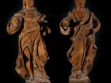 pair of carved wood figures of a man and a woman holding a basket