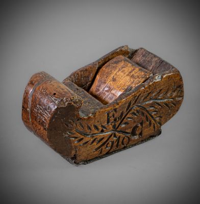 an old wooden plane with a carved design on the side