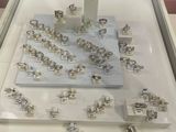 a display case with a lot of silver rings on it