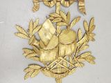 a gold plate with a bird and flowers on it