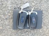 two car keys sitting on top of a black box