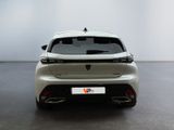 the rear end of a white car in a white room