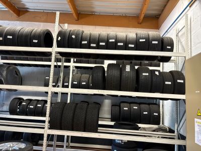 a lot of tires on the shelves in the garage