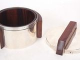 a silver cup with a wooden handle next to a silver cup with a wooden handle