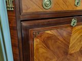 a wooden cabinet with a marble top in a room