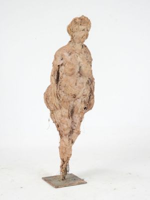 sculpture of a woman standing on a square base with a white background
