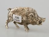 silver figurine of a pig with a price tag on it ' s back