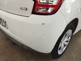 rear end of a white car with a number plate on the back of it