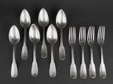 six silver spoons and six forks on a black surface
