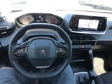 a man sitting in the driver ' s seat of a car