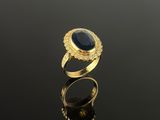 a gold ring with a blue stone surrounded by diamonds