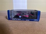 a toy car in a box sitting on a table