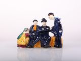 a figurine of a group of people sitting on a bench