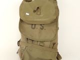 an old us military backpack sitting on top of a white floor