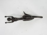 a metal object that looks like a person holding a knife
