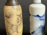 three small vases sitting next to each other on a table