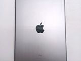 an apple ipad sitting on top of a white table next to a white wall