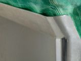 a close up of a bed with a green cover on it