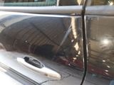 a close up of a car door handle with a hole in it