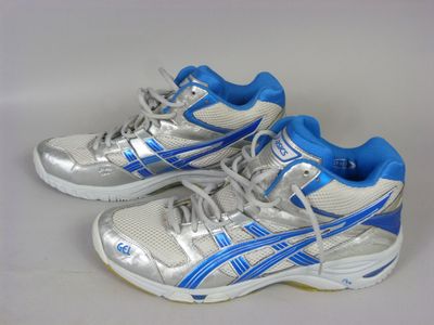 pair of silver and blue running shoes on a white surface