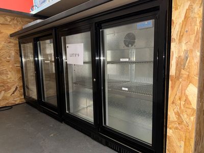 three glass doors that are open in a store