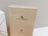 a box of swiss arabian perfume sitting on a table next to a white box