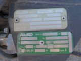 a close up of a motorcycle with a green tag on it