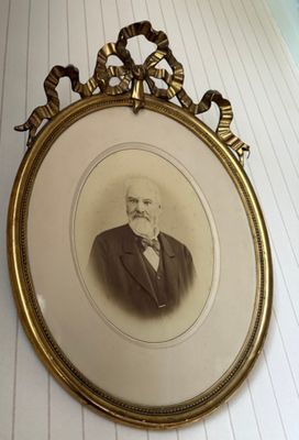 a picture of a man in a suit hanging on a wall