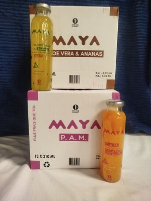 two bottles of orange juice sitting next to a box of orange juice