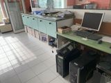 a desk with two computers and a monitor on it