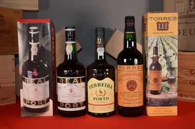several bottles of wine are lined up on a red table