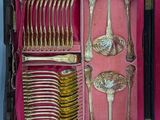 a pink box with silverware in it on a table
