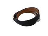 a close up of a black leather bracelet on a white background