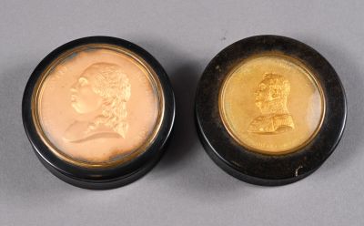 two gold coins with a portrait of a man and a woman on them