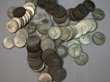 a pile of coins sitting on a table next to each other