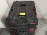 a black crate sitting on the floor next to a wall
