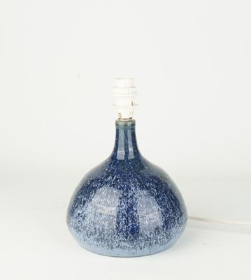 un petit vase bleu surmonté d'une lampe