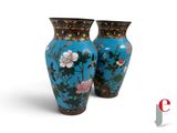 two vases with flowers painted on them on a white background