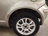 a close up of a white car with a flat tire