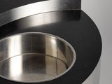 a close up of a stainless steel sink on a black table
