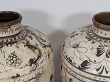 two vases sitting side by side on a table