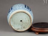 a blue and white vase sitting next to a wooden stand