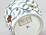 an image of a white vase with a floral design on it