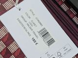 a tag on a piece of luggage that is sitting on the ground