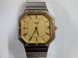 a silver and gold watch with roman numerals on it