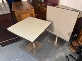 two tables that are sitting next to each other on the floor