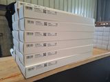 several white boxes stacked on top of each other on top of a table